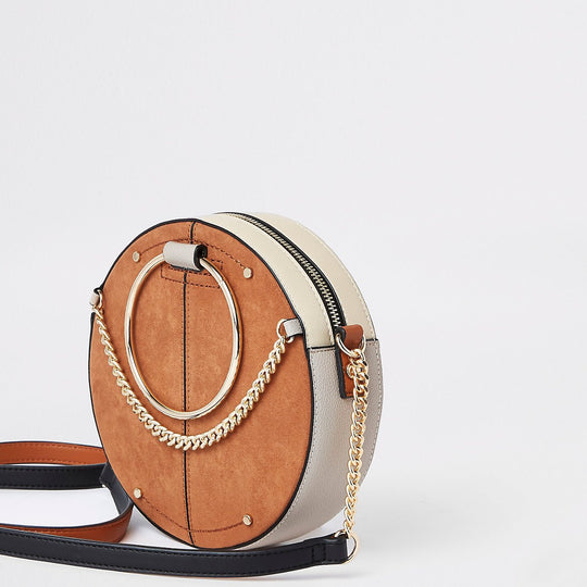 Beige ring handle circle cross body bag